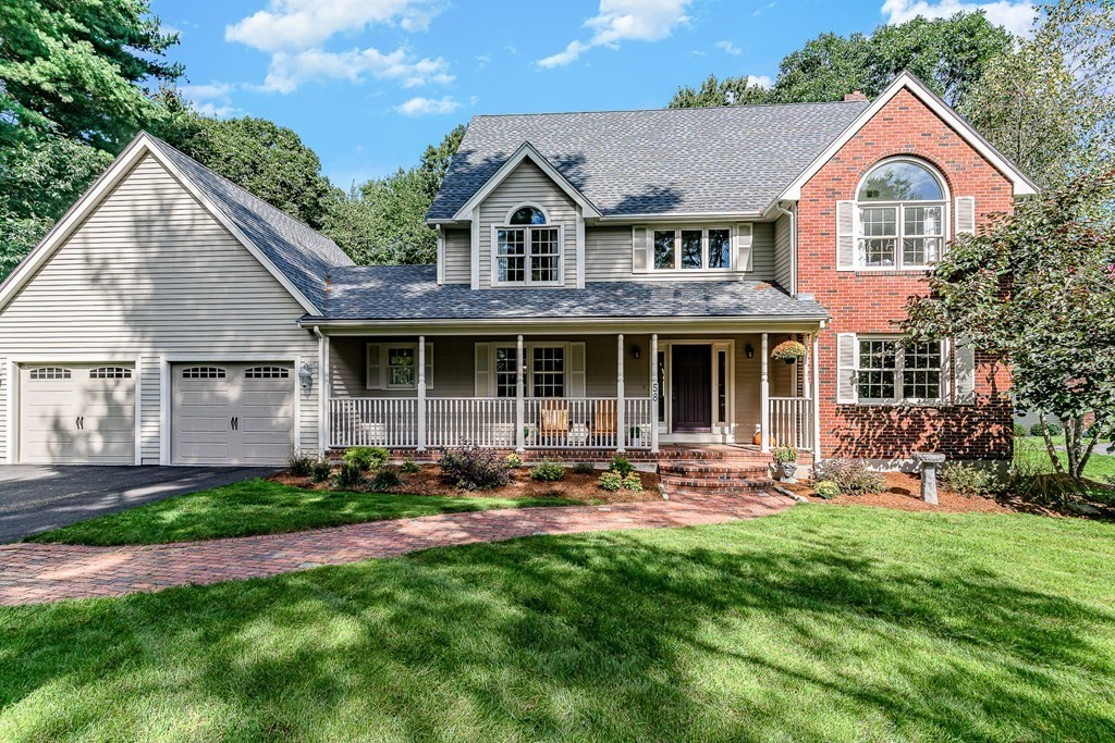 a front view of a house with a yard and outdoor seating