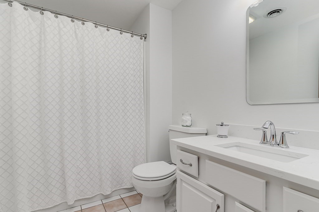 58 York Road Mansfield, MA 02048 - Photo 24 of 42 a bathroom with a sink a toilet and a mirror