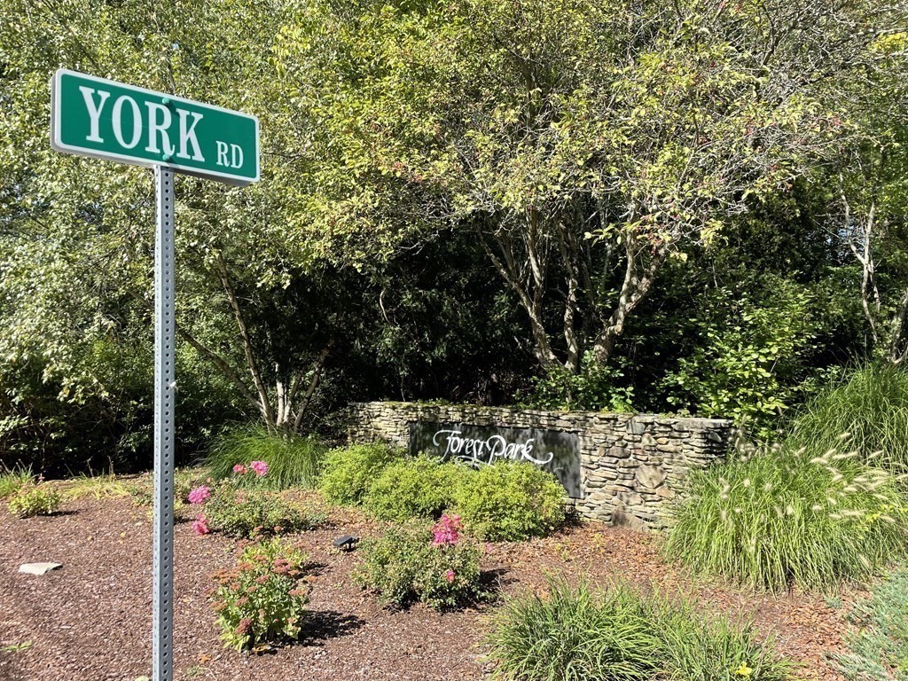 58 York Road Mansfield, MA 02048 - Photo 39 of 42 a street sign that is in front of flowers