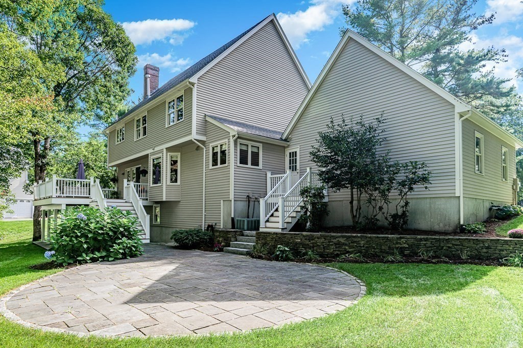58 York Road Mansfield, MA 02048 - Photo 4 of 42 a view of a white house next to a yard with plants and trees