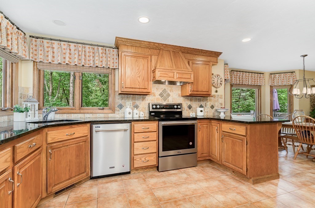 58 York Road Mansfield, MA 02048 - Photo 5 of 42 a kitchen with stainless steel appliances granite countertop a stove a sink and a microwave