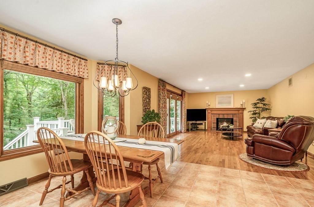 58 York Road Mansfield, MA 02048 - Photo 8 of 42 a living room with furniture a flat screen tv and floor to ceiling windows