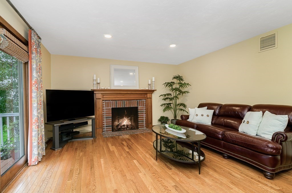 58 York Road Mansfield, MA 02048 - Photo 10 of 42 a living room with furniture a flat screen tv and a fireplace