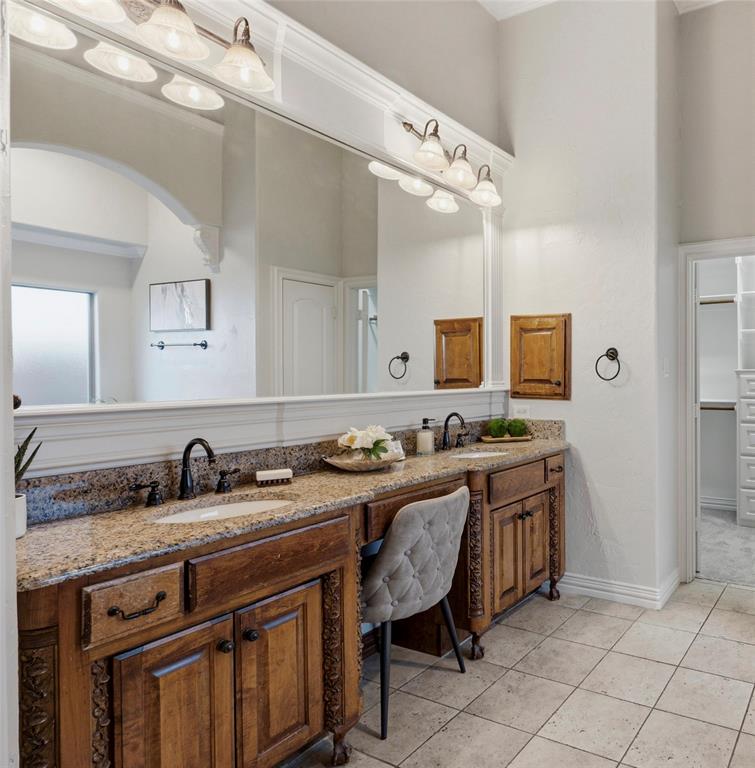 620 Highview Lane Hurst, TX 76054 - Photo 25 of 40 Dual vanity with undermount sinks, granite countertops, and dark wood cabinetry