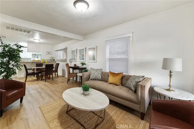 a living room with furniture kitchen view and a table