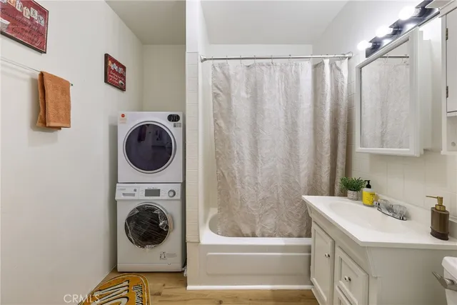 a bathroom with a sink a washer and dryer
