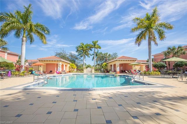 a swimming pool with outdoor seating and yard