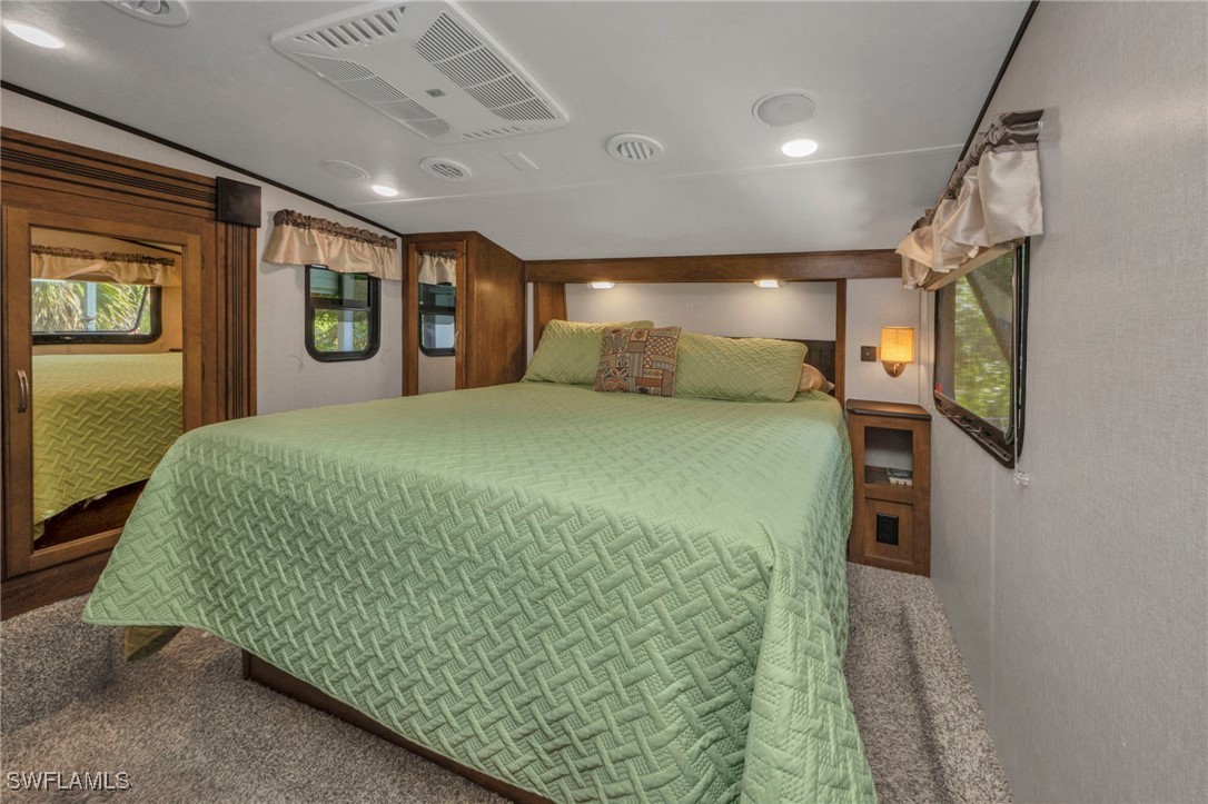 1269 Northwest Peace Pointe Drive Arcadia, FL 34266 - Photo 15 of 21 a large bed sitting in a large room next to a lamp