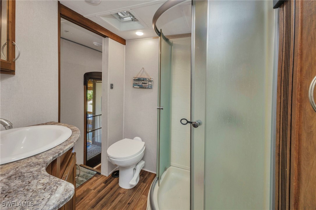 1269 Northwest Peace Pointe Drive Arcadia, FL 34266 - Photo 16 of 21 a bathroom with a toilet and a shower