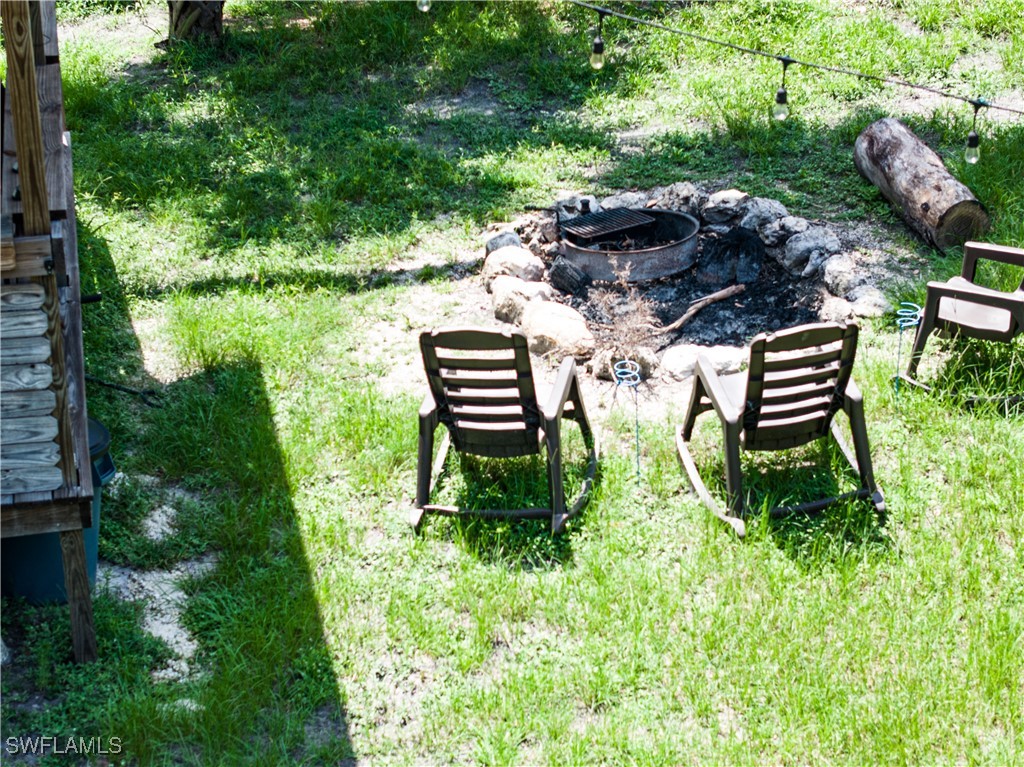 1269 Northwest Peace Pointe Drive Arcadia, FL 34266 - Photo 17 of 21 a view of a bench in the garden near a lake