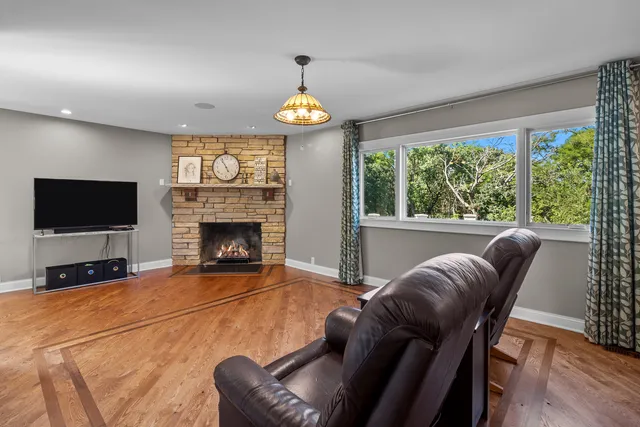 a living room with furniture a large window and a flat screen tv