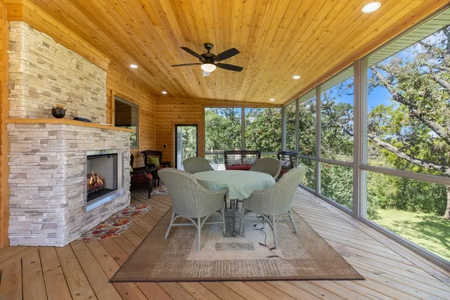 a dining room with furniture a fireplace and wooden floor