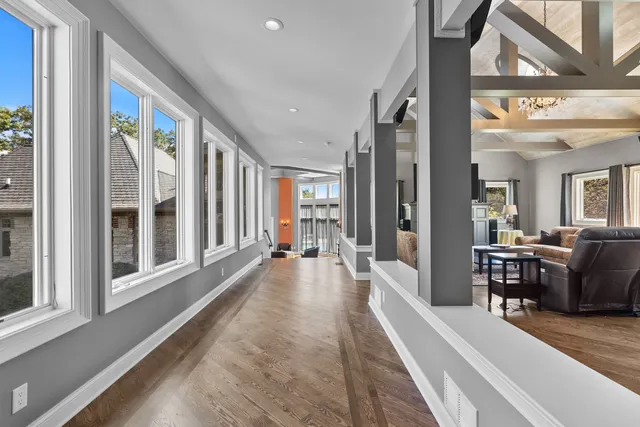 a living room with furniture and large windows