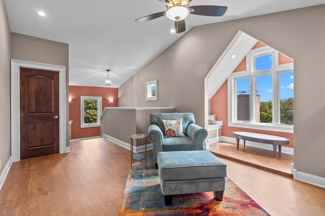 a view of a house with a big yard and large trees