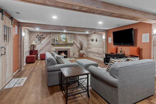 a room with pool table and wooden floor