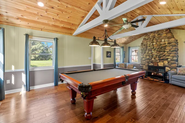 a bathroom with a granite countertop sink a toilet and shower