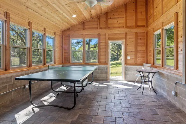 a view of a house with a yard and tree