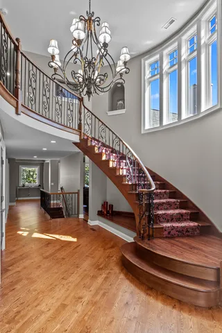 a view of entryway and hall with wooden floor