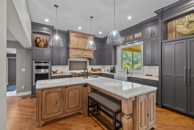 a kitchen with a sink a counter space appliances and a window