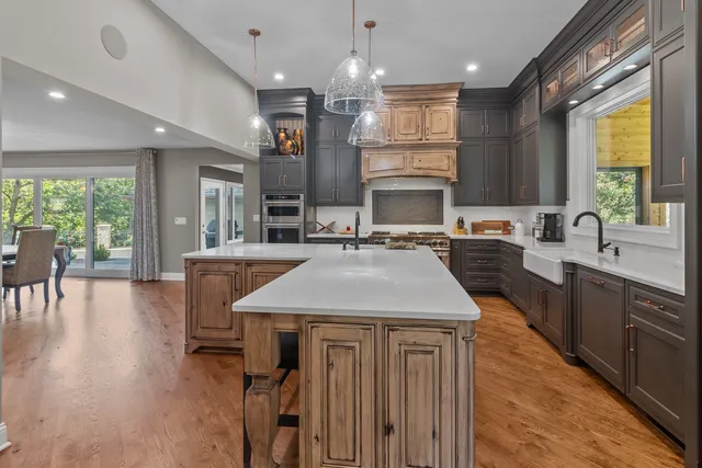 a kitchen with a table chairs sink and cabinets