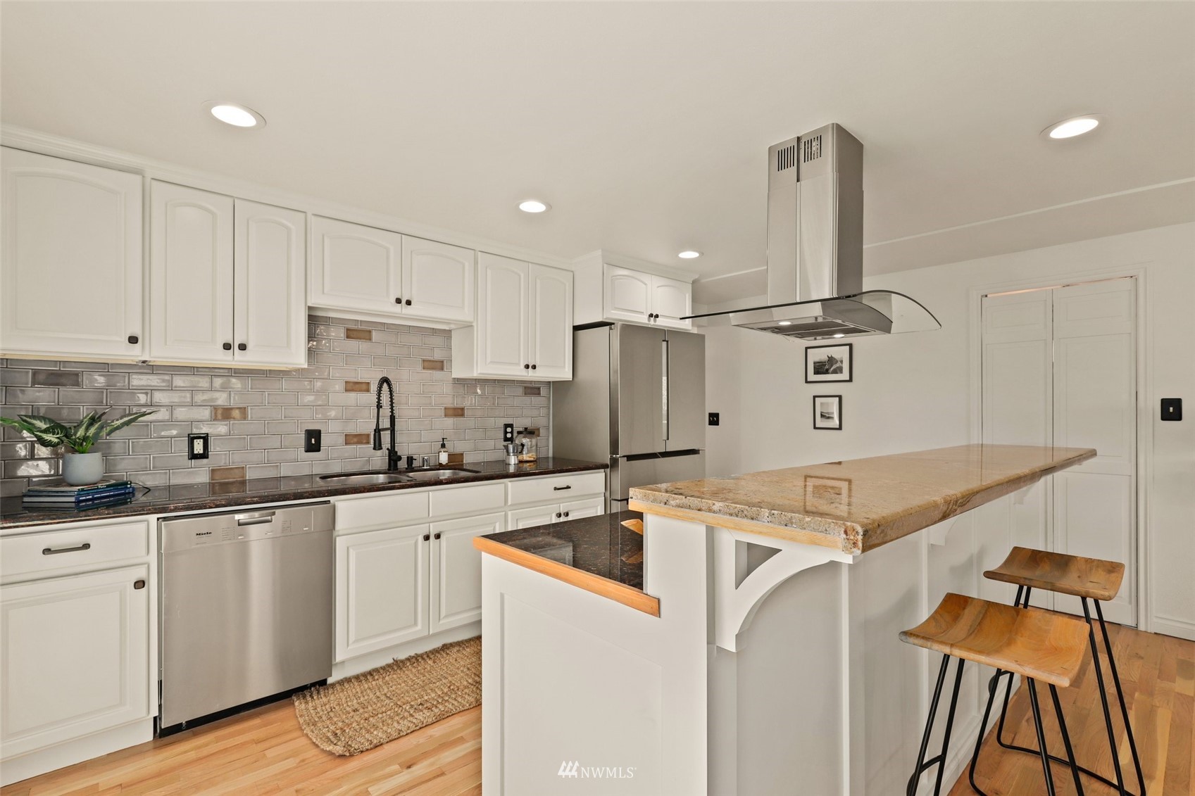 8817 37th Avenue Southwest Seattle, WA 98126 - Photo 11 of 40 a kitchen with a sink a stove and cabinets