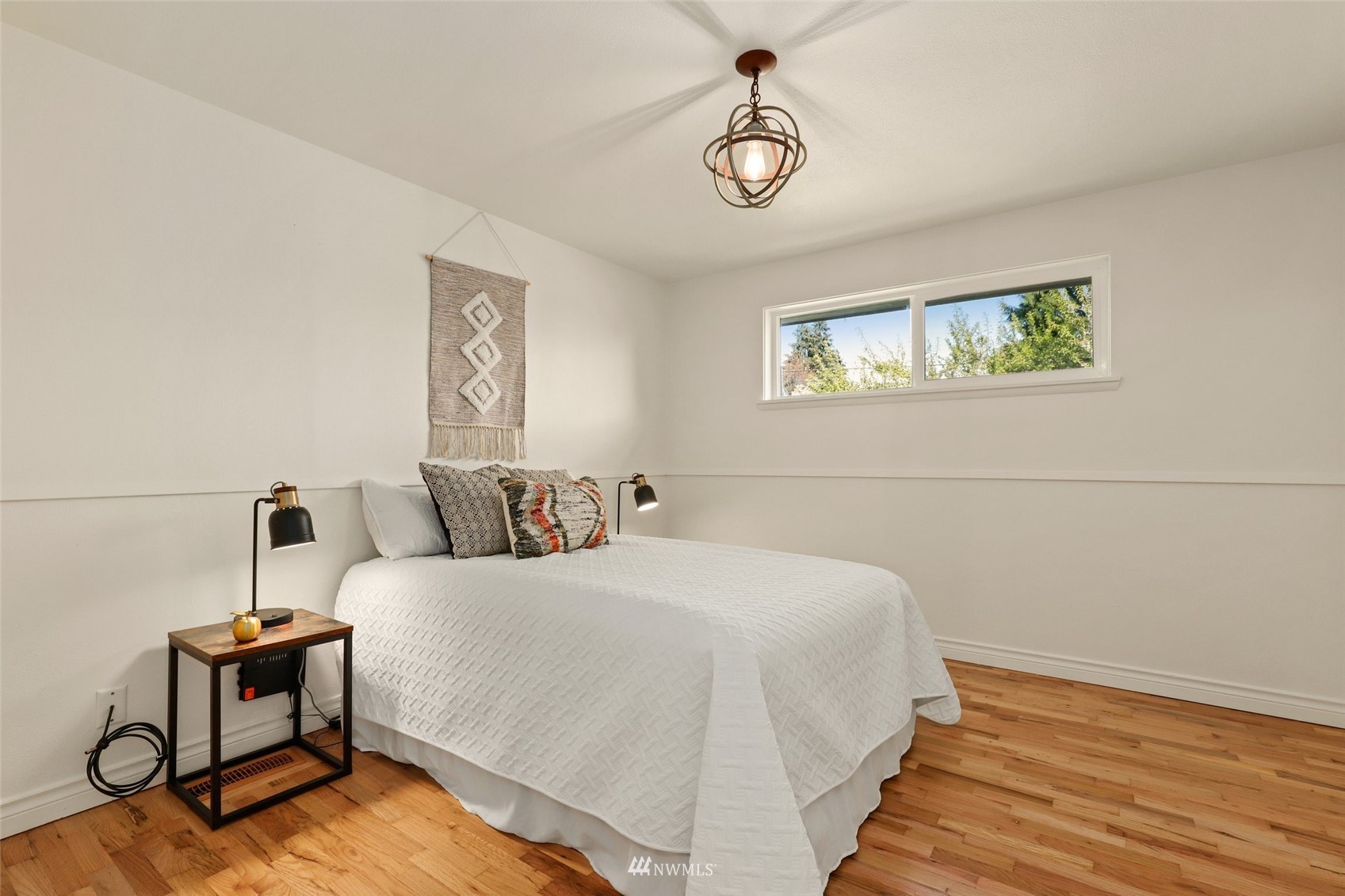 8817 37th Avenue Southwest Seattle, WA 98126 - Photo 14 of 40 a bedroom with a bed and wooden floor