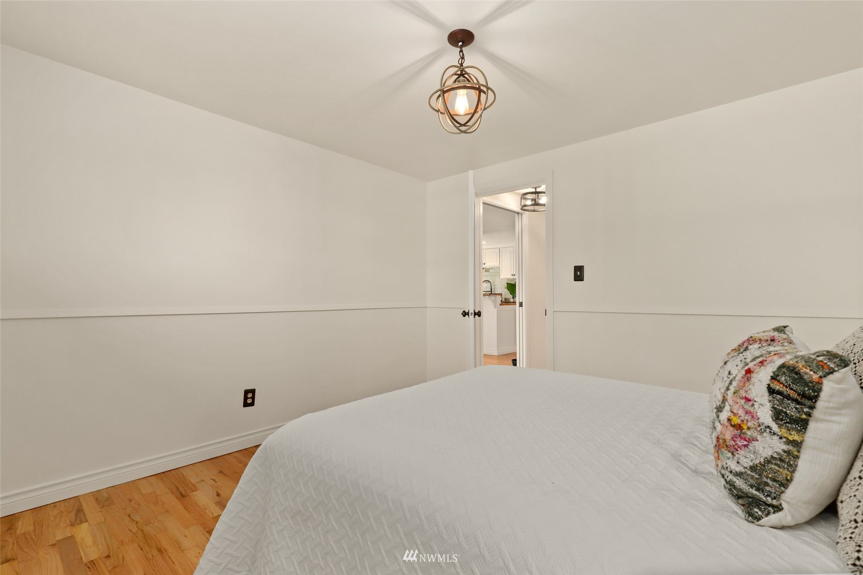 8817 37th Avenue Southwest Seattle, WA 98126 - Photo 15 of 40 a bedroom with a bed and a chandelier