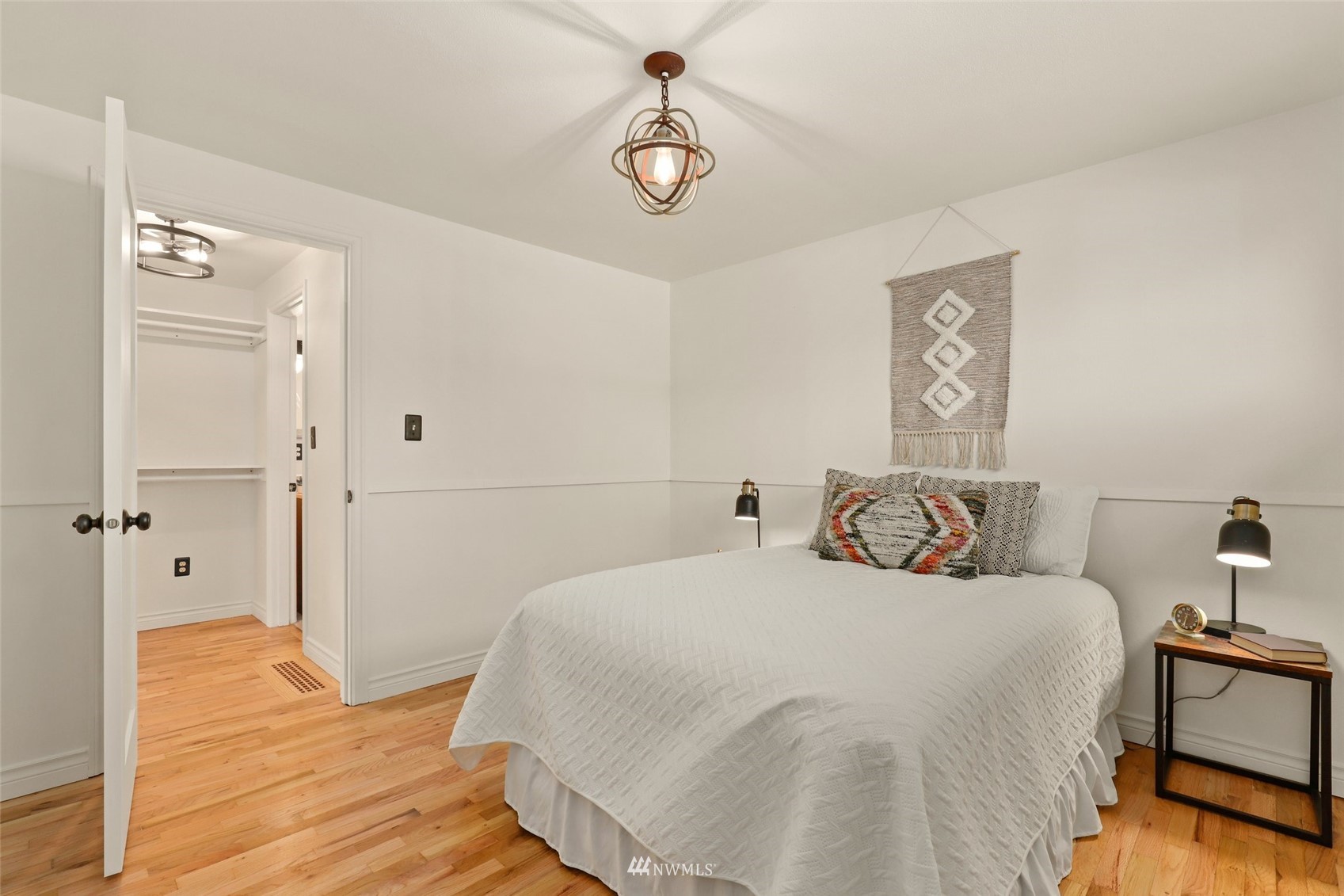8817 37th Avenue Southwest Seattle, WA 98126 - Photo 16 of 40 a bedroom with a bed and wooden floor