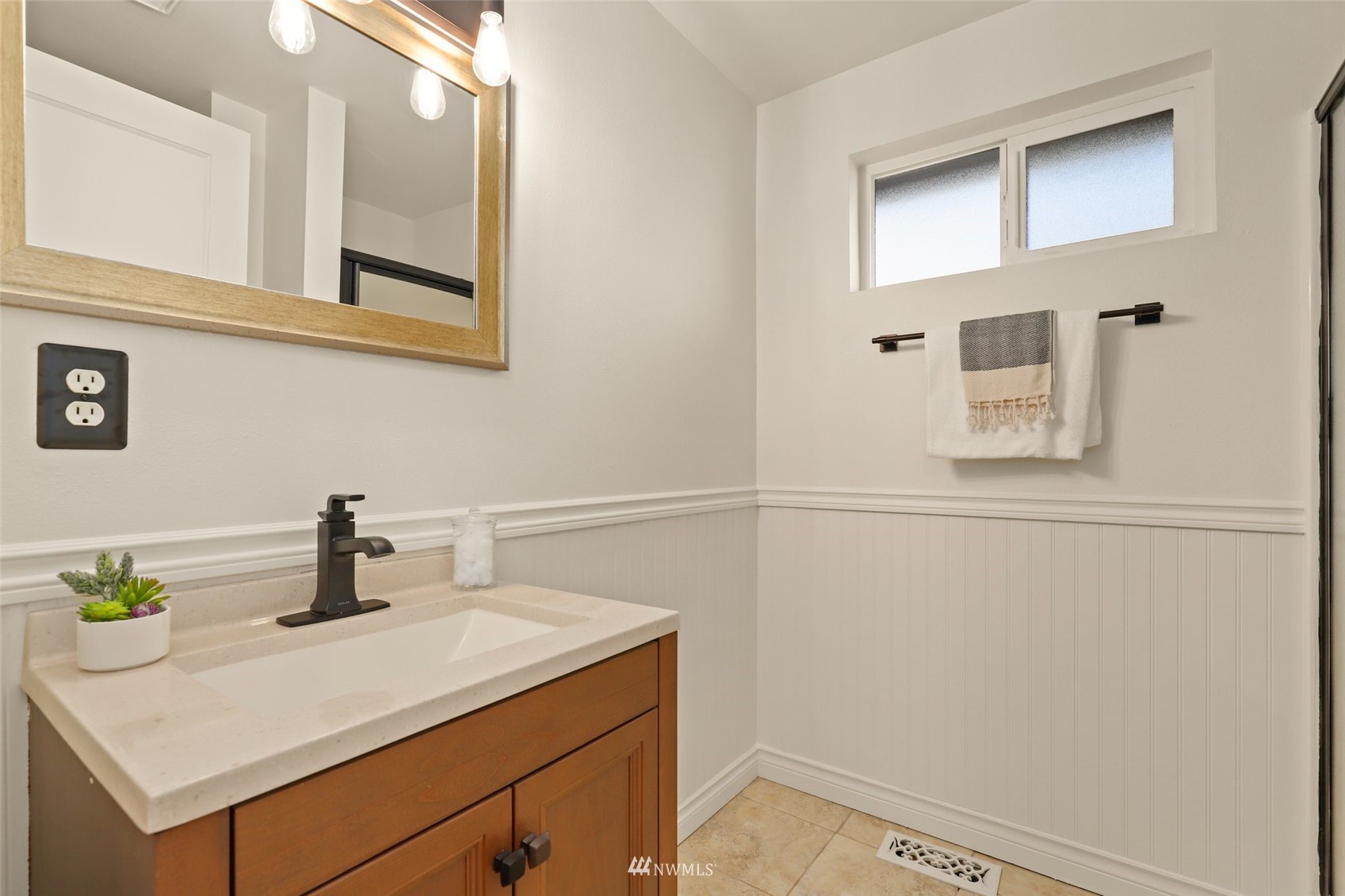 8817 37th Avenue Southwest Seattle, WA 98126 - Photo 18 of 40 a bathroom with a sink and a mirror