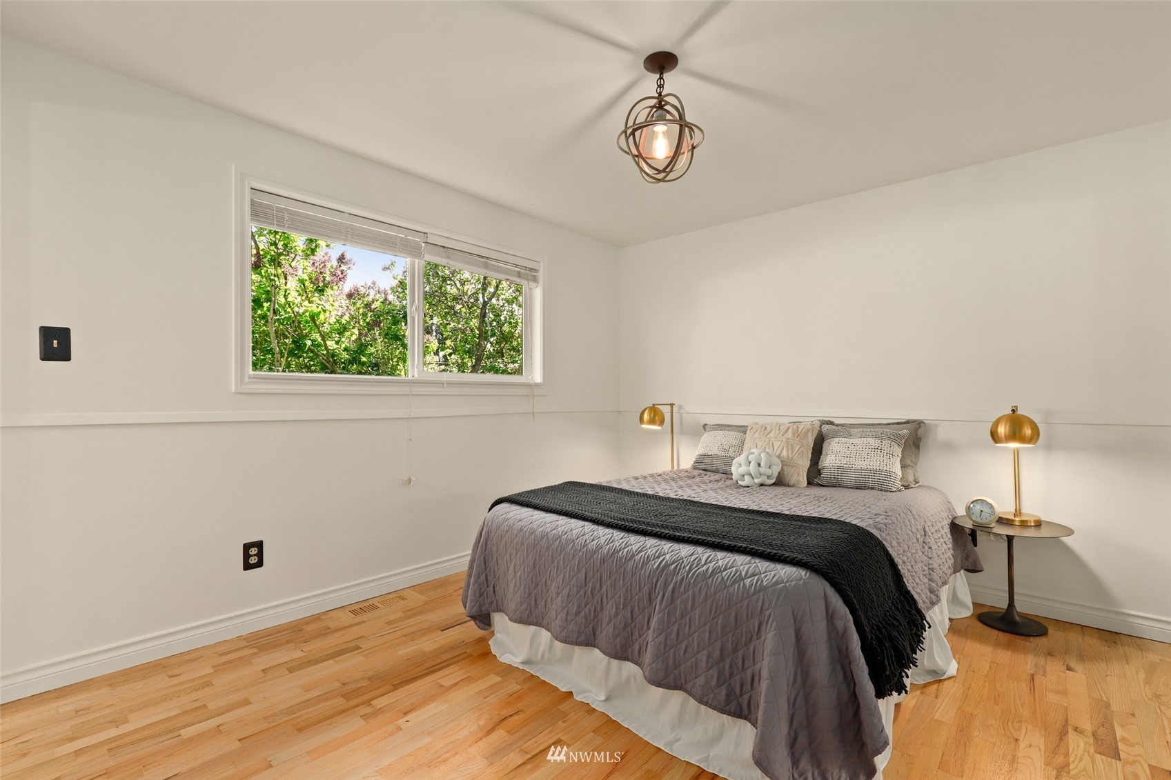 8817 37th Avenue Southwest Seattle, WA 98126 - Photo 19 of 40 a bedroom with a bed and a window