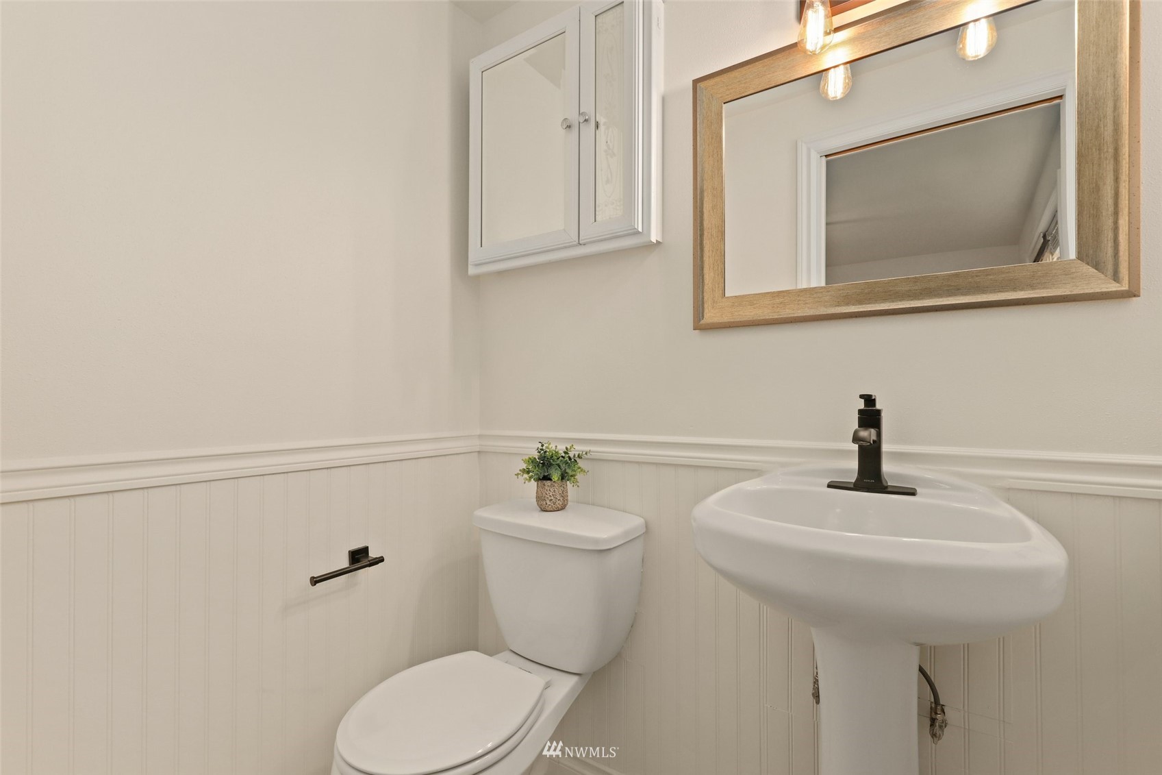 8817 37th Avenue Southwest Seattle, WA 98126 - Photo 22 of 40 a bathroom with a toilet a sink and mirror