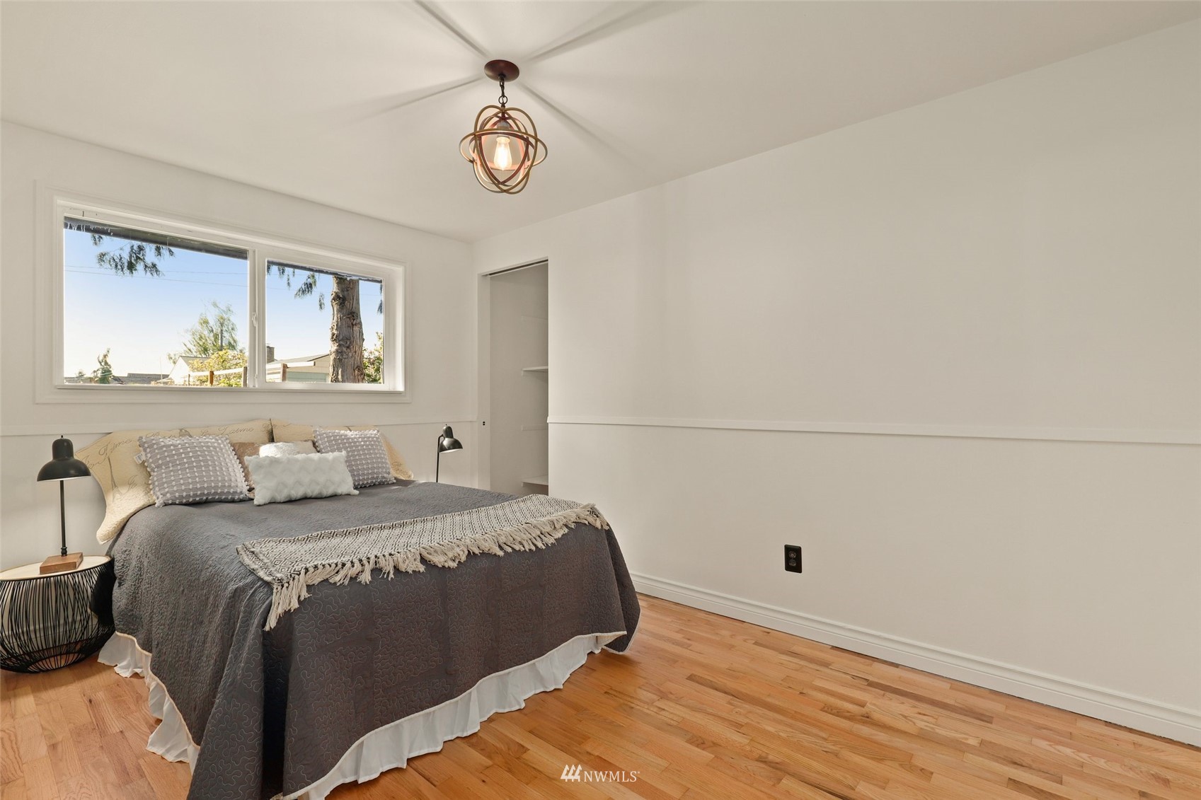 8817 37th Avenue Southwest Seattle, WA 98126 - Photo 23 of 40 a bedroom with a bed and a window