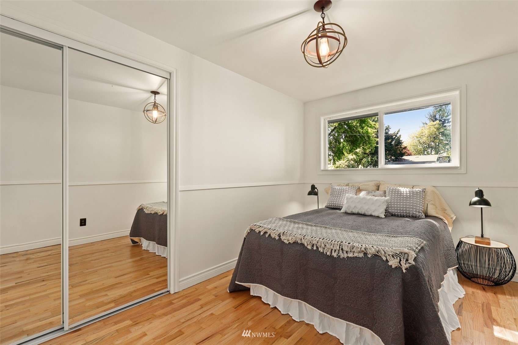 8817 37th Avenue Southwest Seattle, WA 98126 - Photo 24 of 40 a bedroom with a bed and wooden floor