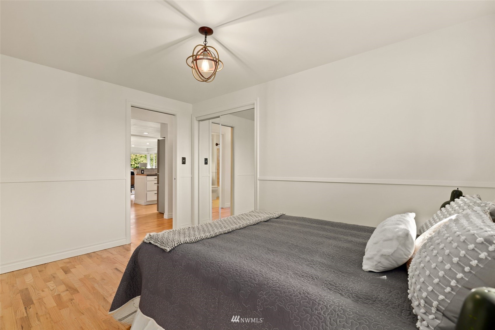 8817 37th Avenue Southwest Seattle, WA 98126 - Photo 25 of 40 a bedroom with a bed and a chandelier
