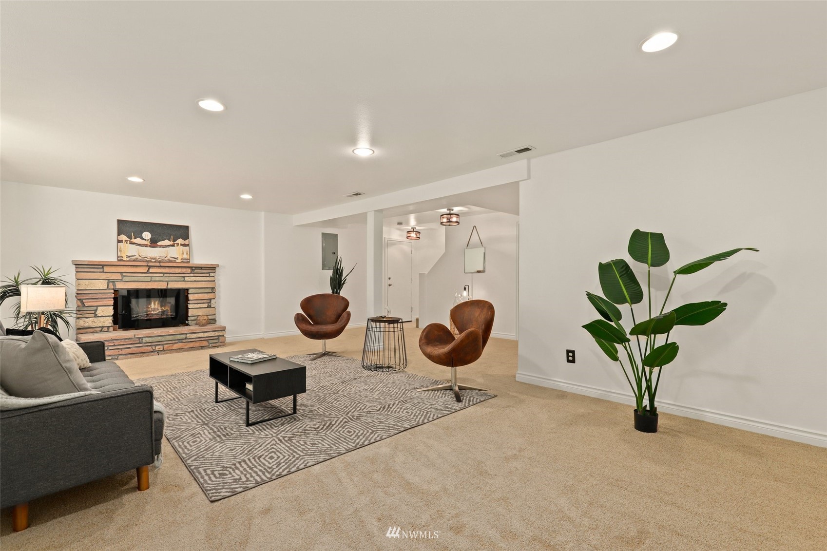 8817 37th Avenue Southwest Seattle, WA 98126 - Photo 27 of 40 a living room with furniture a potted plant and a fireplace