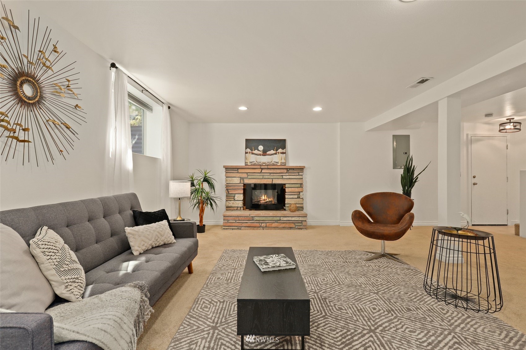 8817 37th Avenue Southwest Seattle, WA 98126 - Photo 28 of 40 a living room with furniture a rug and a fireplace