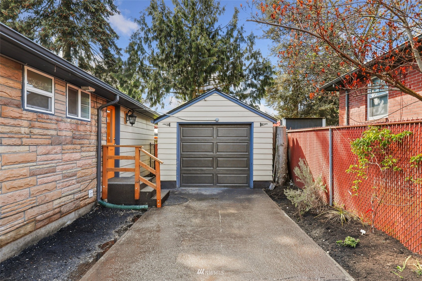 8817 37th Avenue Southwest Seattle, WA 98126 - Photo 39 of 40 a front view of a house with a garage