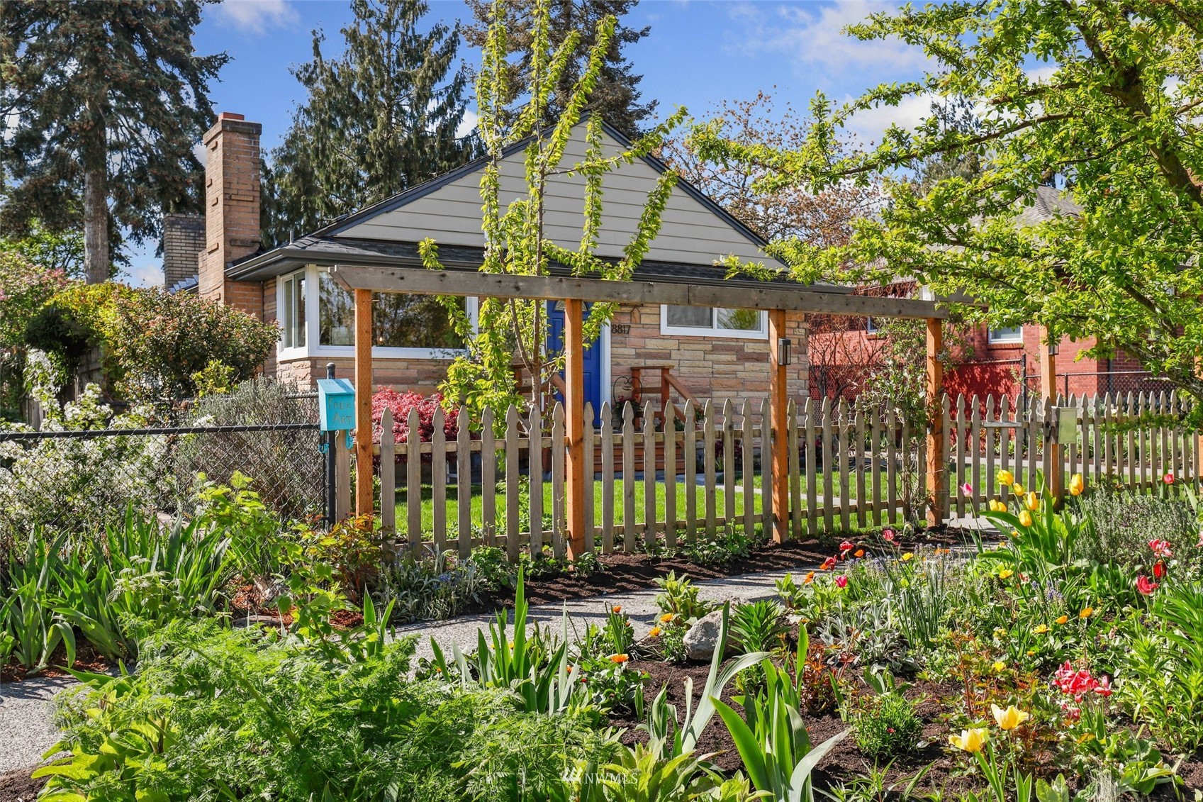 8817 37th Avenue Southwest Seattle, WA 98126 - Photo 40 of 40 a view of a house with a garden and plants