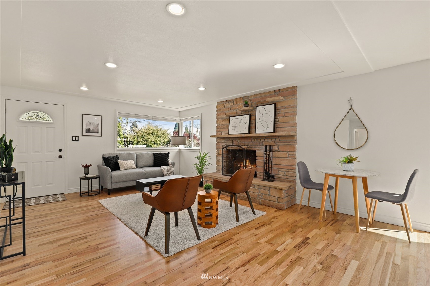8817 37th Avenue Southwest Seattle, WA 98126 - Photo 5 of 40 a living room with furniture a fireplace and a window