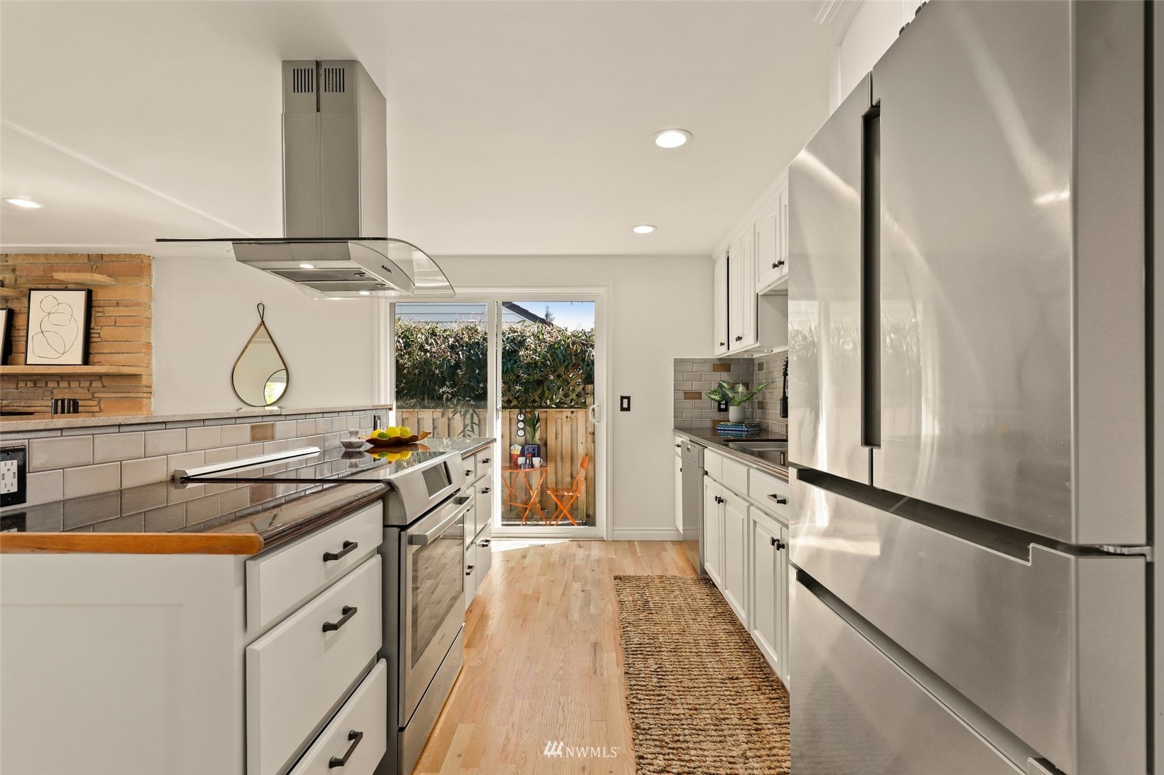 8817 37th Avenue Southwest Seattle, WA 98126 - Photo 8 of 40 a kitchen with stainless steel appliances a sink stove and refrigerator