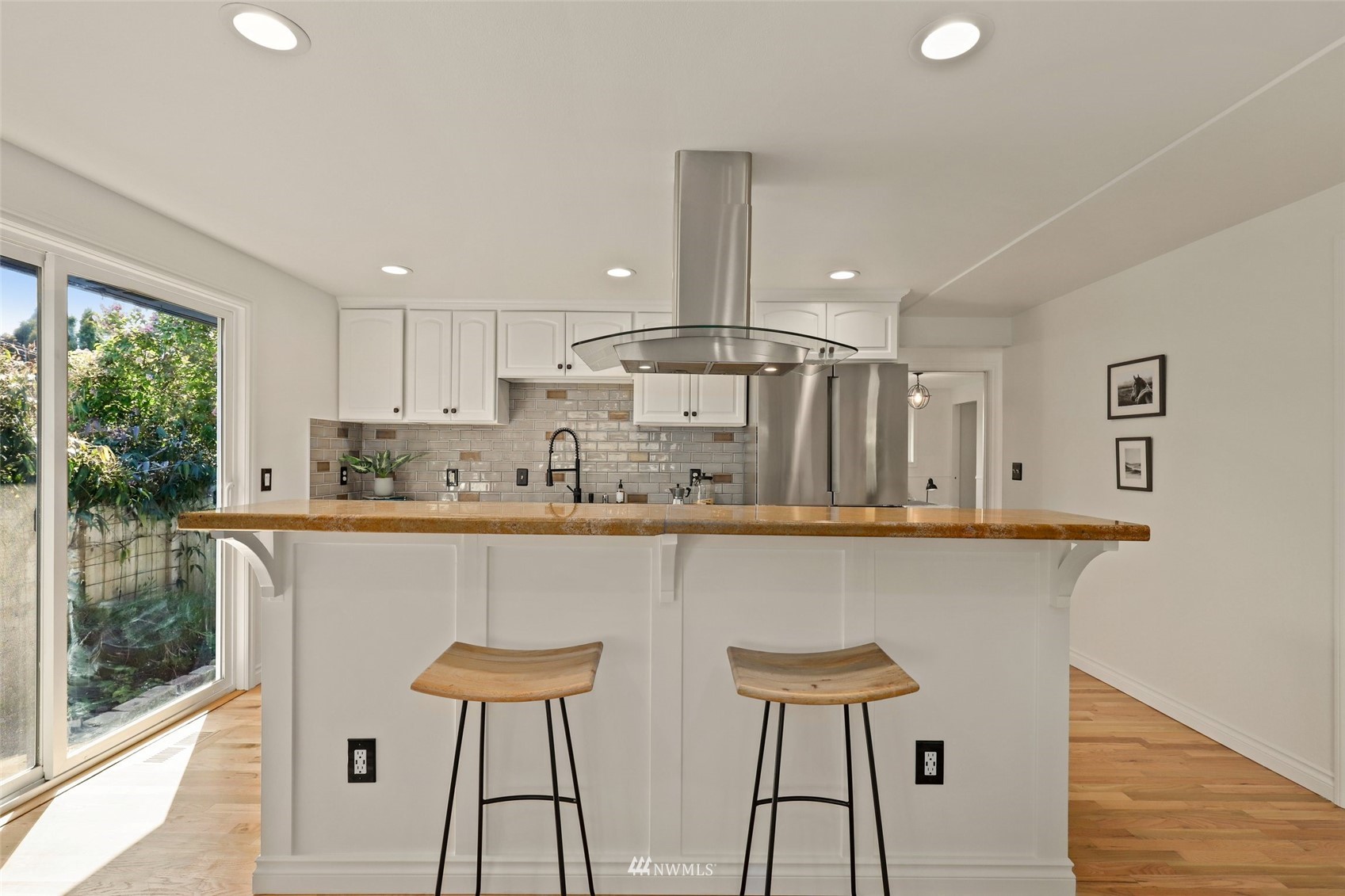 8817 37th Avenue Southwest Seattle, WA 98126 - Photo 10 of 40 a kitchen with stainless steel appliances a table chairs refrigerator and chair