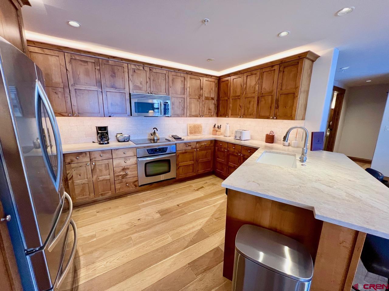 14 Hunter Hill Road, Unit C203 Crested Butte, CO 81225 - Photo 11 of 34 a kitchen with stainless steel appliances sink microwave and stove