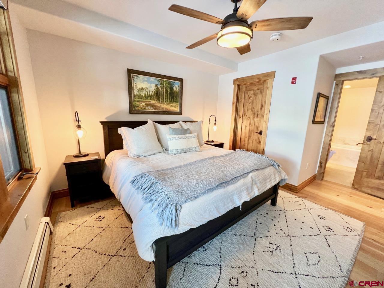 14 Hunter Hill Road, Unit C203 Crested Butte, CO 81225 - Photo 13 of 34 a bedroom with a bed and a flat screen tv