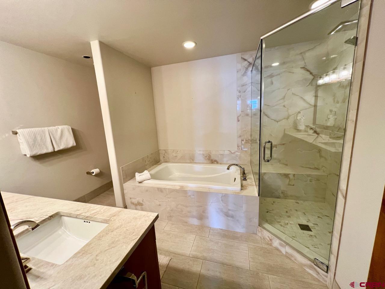 14 Hunter Hill Road, Unit C203 Crested Butte, CO 81225 - Photo 15 of 34 a bathroom with a shower and a sink