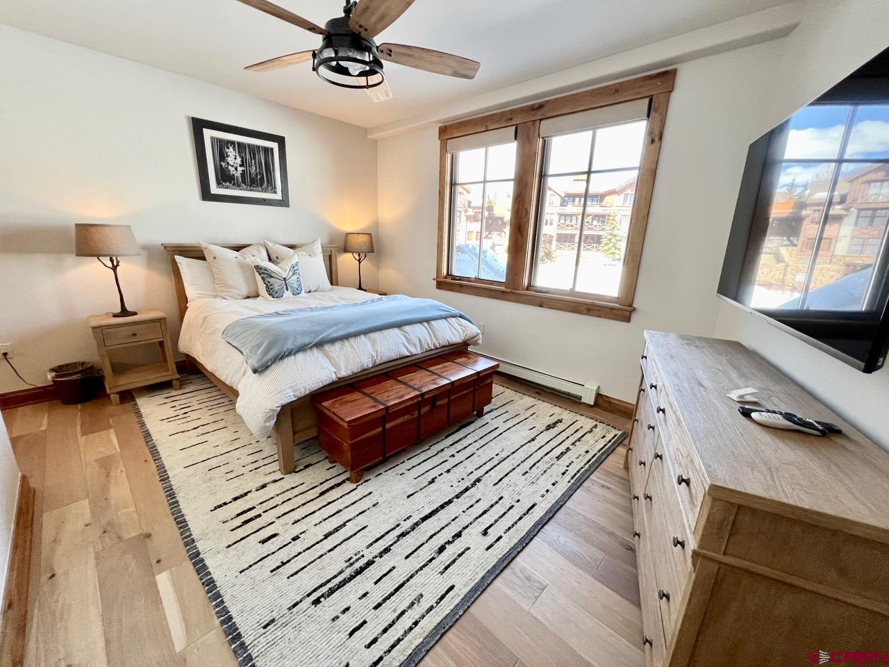 14 Hunter Hill Road, Unit C203 Crested Butte, CO 81225 - Photo 17 of 34 a bedroom with a bed and a tv on the dresser