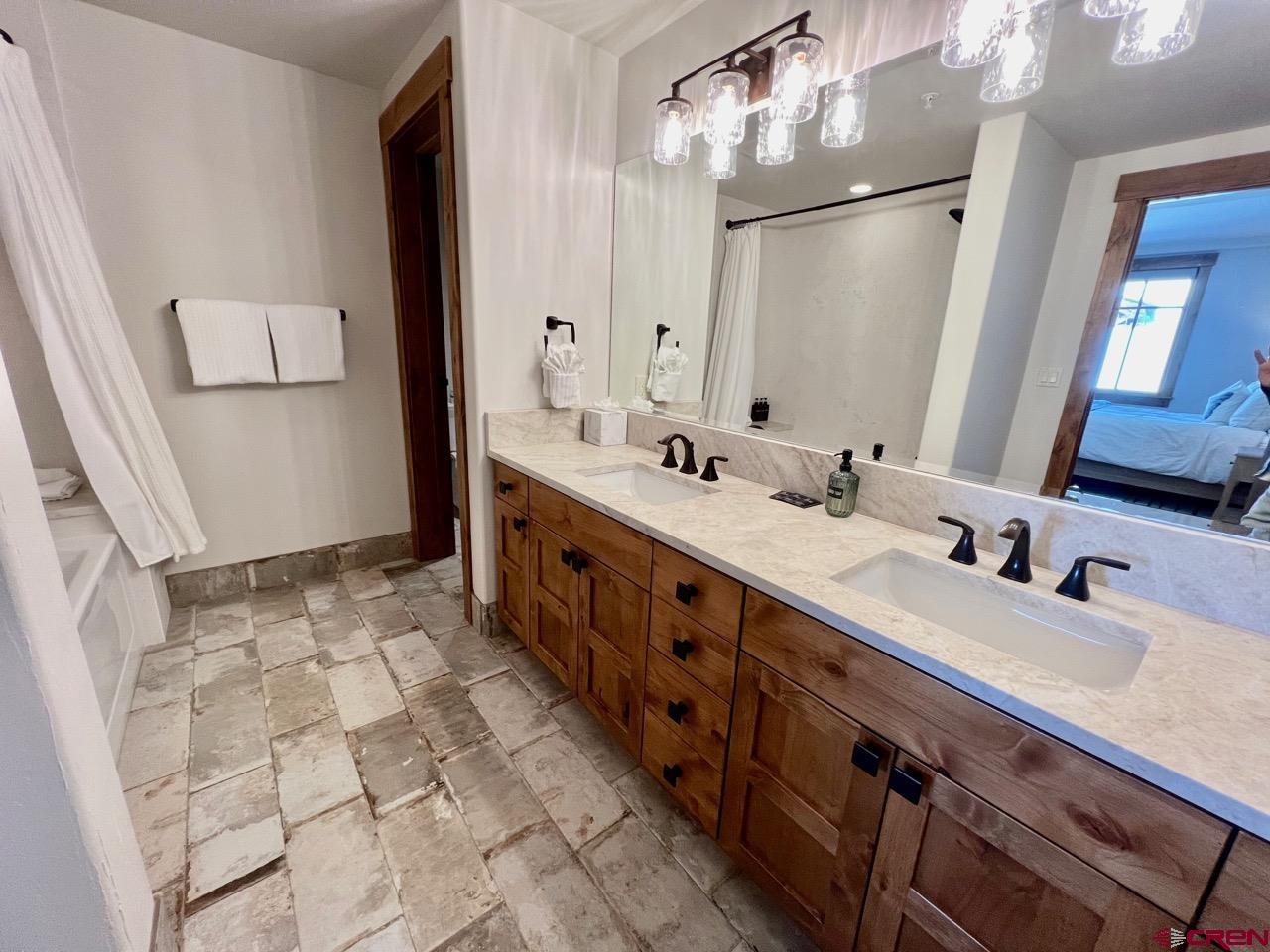 14 Hunter Hill Road, Unit C203 Crested Butte, CO 81225 - Photo 19 of 34 a bathroom with a double vanity sink mirror and double