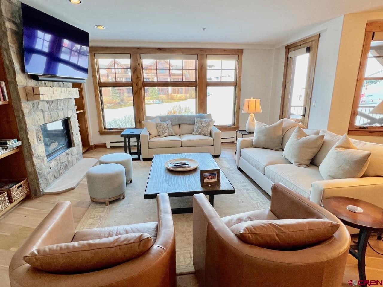 14 Hunter Hill Road, Unit C203 Crested Butte, CO 81225 - Photo 5 of 34 a living room with furniture and a large window