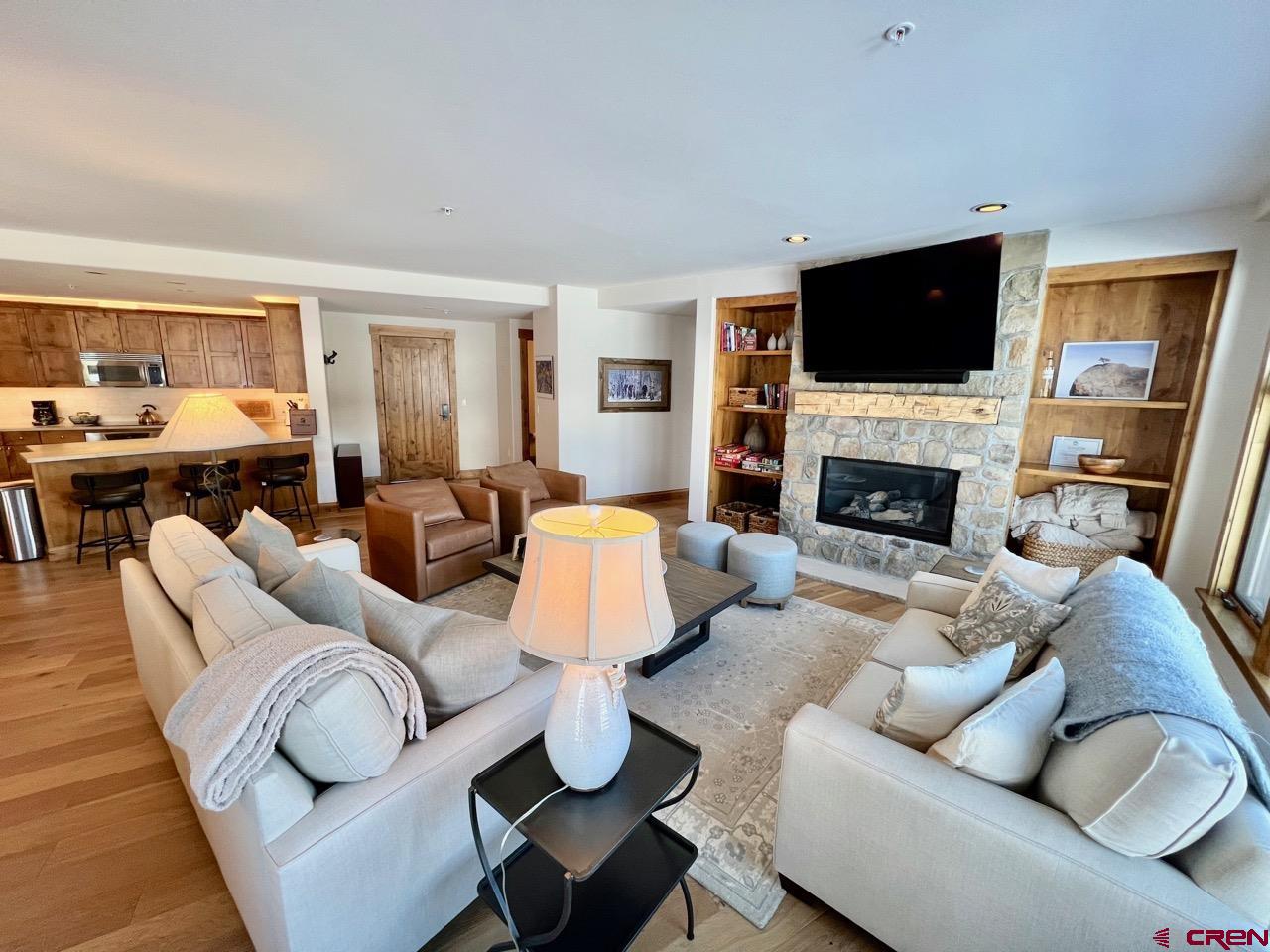 14 Hunter Hill Road, Unit C203 Crested Butte, CO 81225 - Photo 7 of 34 a living room with furniture fireplace and a flat screen tv