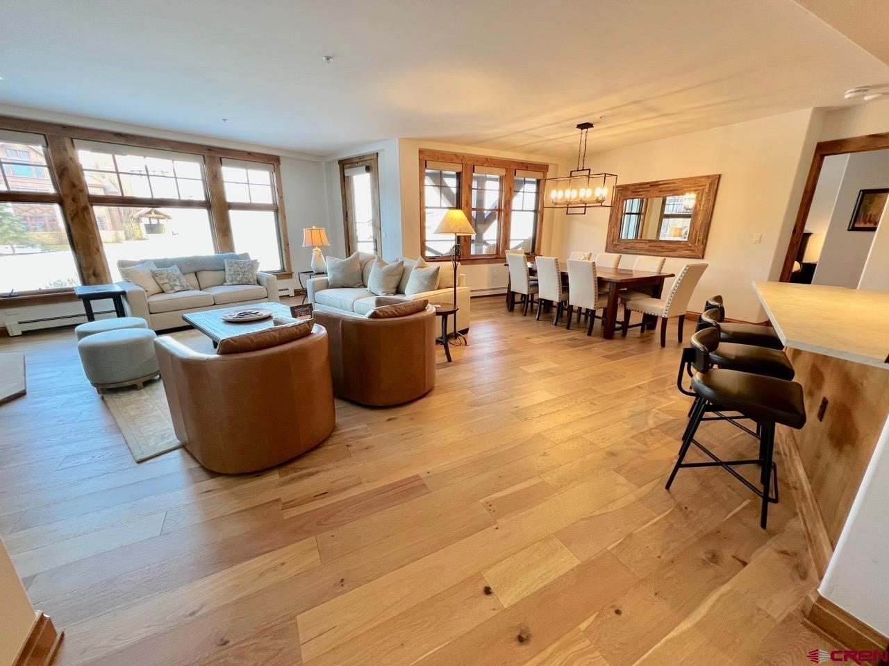 14 Hunter Hill Road, Unit C203 Crested Butte, CO 81225 - Photo 8 of 34 a living room with furniture a large window and wooden floor