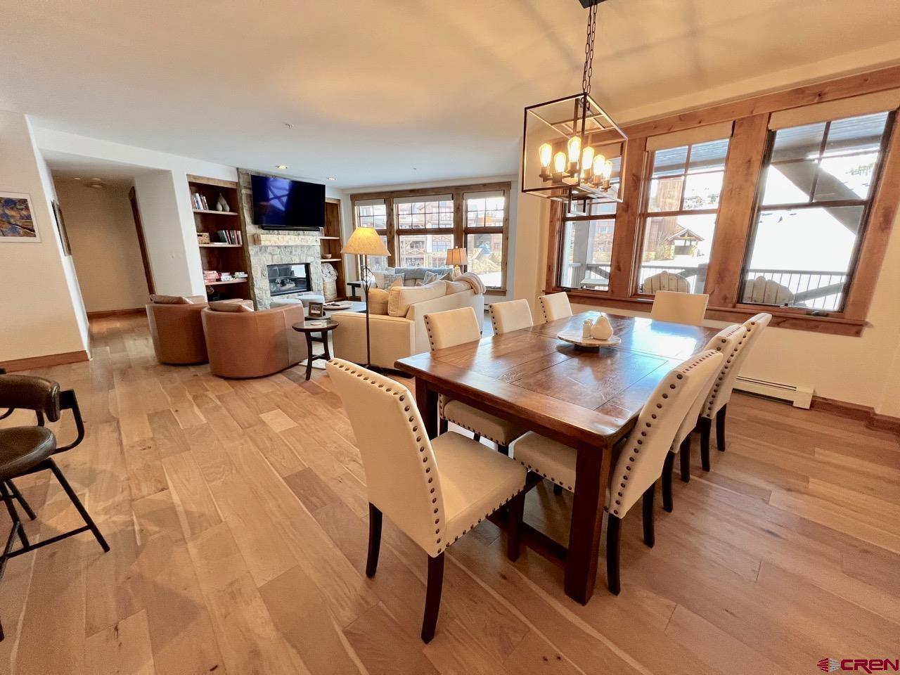 14 Hunter Hill Road, Unit C203 Crested Butte, CO 81225 - Photo 9 of 34 a view of a dining room with furniture window and wooden floor